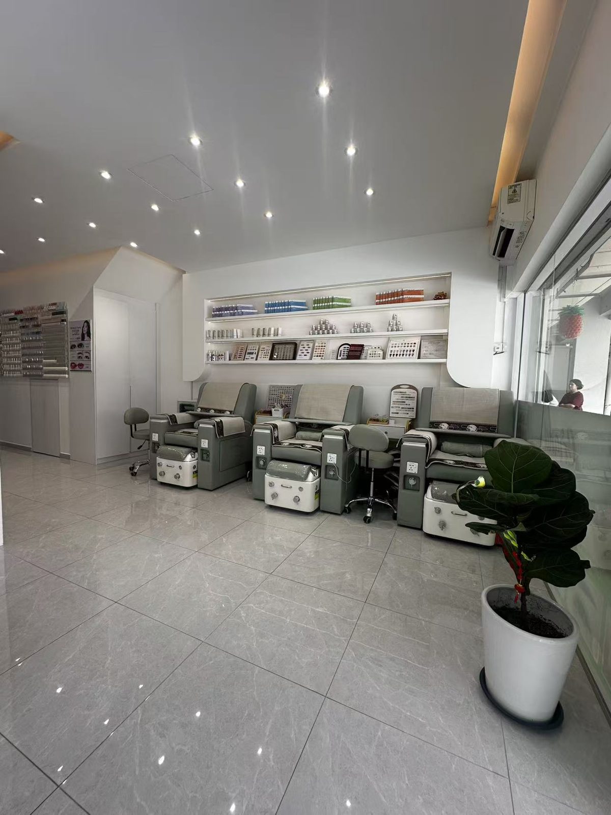 The pedicure room with a row of stations